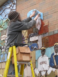 Judith Inglese fitting the tile into place.