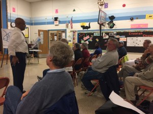 Residents listen to Tasfai Gieorgis of WSSC explain the upcoming water main replacement project in Twinbrook.